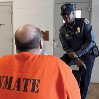 Correction officer talks with inmate
