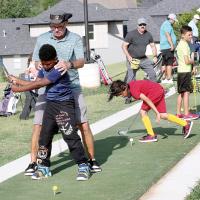 Jimmy Wiewel shows B.J. Dixon how to rotate his shoulders in his backswing