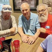Joe Garcia poses for a photo with Barry Switzer and Toby Keith