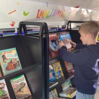 John Conner looks at a popular book on video games inside the Bookmobile