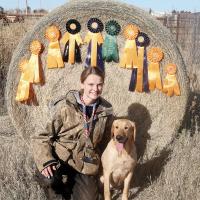 Julie Holdcraft poses with some of the ribbons won by her dog, Birdie 
