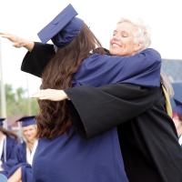 EHS educator Kandy Connor gives a graduate a hug