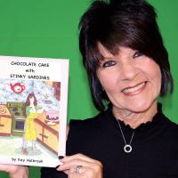 Kay Holbrook holds up a copy of the book she recently had published
