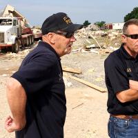 Ken Brown, left, and Kent Lagaly discuss tornado damage