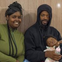 Kori Petty and Unadre McLillan sit with her baby