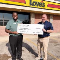 Aaron Gatlin presents Tim Pounds with a $6,000 donation