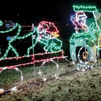 Jovanny Rosas looks at this Santa Claus driving a tractor display