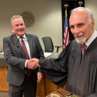 Steve Jensen congratulates retiring Municipal Judge Richard Lewis