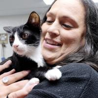 Lindsey Grigg-Moak snuggles with a cat at the animal shelter