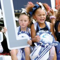 Members of El Reno’s youth cheerleading squad ride on a float