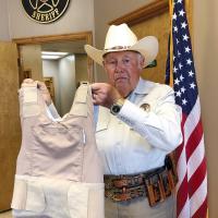 Mike Grimes shows off a protective vest