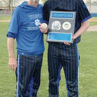 Ludy Griggs and Aiden Williams hold a baseball and the Moss trophy