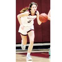 Redlands guard Macy Moore dribbes up the court. 