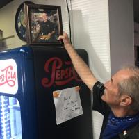 Marty Hall holds the framed photo Bill Edwards gave him