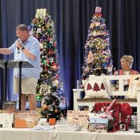 Matt White conducts the auction as Lindsey Vice assists