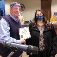 Matt White presents Melodee Worthen with an OKML certificate