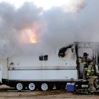 El Reno firefighters work to put out a mobile home fire