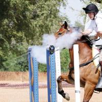 A soldier from Great Britain fires at a balloon during the mounted pistol competition