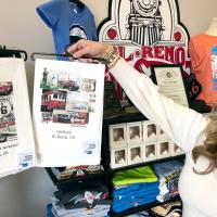 Shana Ford holds up one of the tea towels being sold