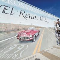 Chris Small touches up the Route 66 mural