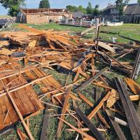 Mike Murray (back right) talks with Bobby Don Stevenson, who had stopped by to check the damage to Murray’s home