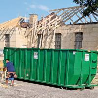 J.T. Chronister’s crew work on a project to replace the roof on the historic Canadian County Jail at Rogers and Evans