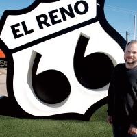 Nolan Stolz stands in front of the Route 66 Monument