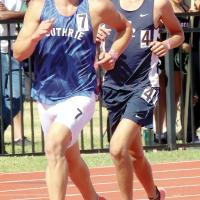 Ethan Brooks (right) runs in step with Guthrie’s Isaiah Blevins