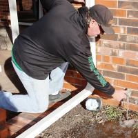 Tony Walker flows water from an outside spigot to test a line
