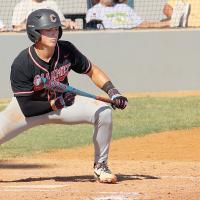 Wyatt Cox drops down a bunt