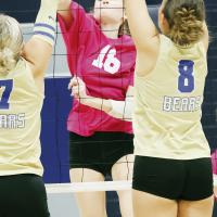 Jillian Reavis hits over a block attempt