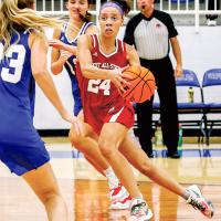 Ashlyn Evans-Thompson works the ball between two defenders