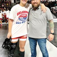 Kaylee Davis poses for a photo with head coach Chad Whitney