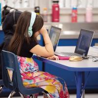 First-graders work on assignments on laptops at Epic Charter School