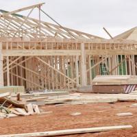 Construction workers frame a duplex in Tuttle