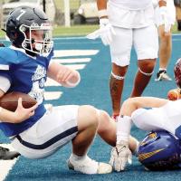 Rustyn Cook falls backward into the end zone for the West’s first touchdown in the 14-0 win