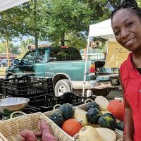 Lacresha Davis looks over the various offerings at her local farmers market