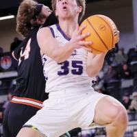 Colin Hendrickson (35) eyes the basket while jumping under the block attempt of a Cheyenne-Reydon defender