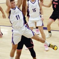 Jett Mueggenborg leaps into the air to grab a rebound