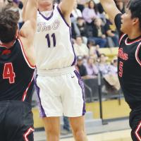 Jett Mueggenborg (11) shoots over two Geary defenders for two points