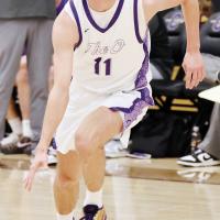 Jett Mueggenborg dribbles the ball up the court