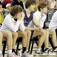 Caden Schieber watches the action from the bench