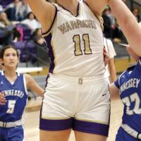 Emma Stover eyes the basket while shooting over a Hennessey defender