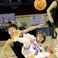 Easton Roby watches the basketball fly down the court after making a diving steal