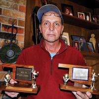 Larry Annuschat shows the trophies that brothers, Ron and Nick brought home in 1979