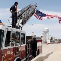 ERFD members use a ladder truck to position the American flag