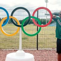 Prince Ezeala stands next to a replica of the Olympic rings in Lille, France
