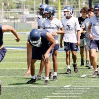 A group of El Reno High School football players run sprints