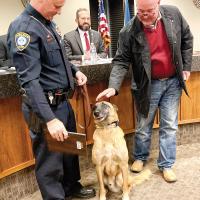 Mayor Steve Jensen pets K-9 Rocco as Sgt. Sandy Dowdle looks on