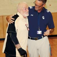 Rodney Haydon hugs Ken Posey during the dedication of the court bearing his name at Etta Dale Junior High